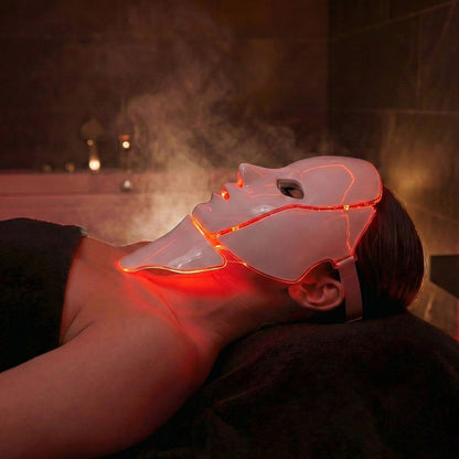 Person using LuceRosso red light therapy mask for skin rejuvenation and anti-aging treatment
